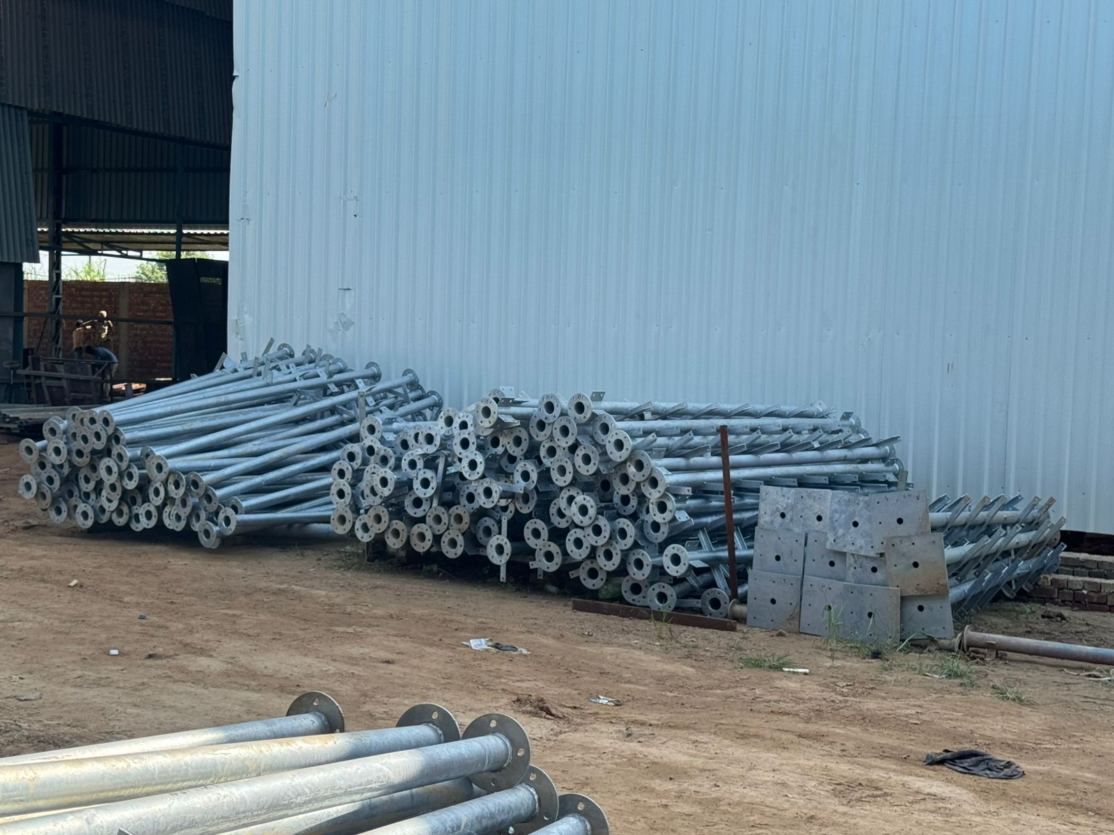 Telecom pole inventory yard with galvanized sections